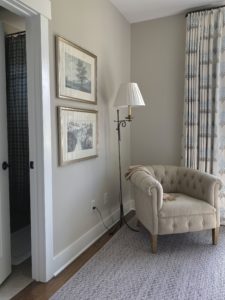 Chair and lamp with two pictures on the walls