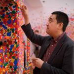 Professor looks at splatter paint closely
