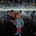 Faculty member with daughter in infinity mirrors