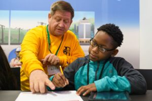 Brenau faculty and staff with middle school students helping write