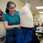 Rebecca Kendrick pins part of a costume on a mannequin for a production of "Monstrous Regiment" in the Brenau University Costume Shop by the Gainesville Theatre Alliance, a partnership between Brenau and the University of North Georgia. (AJ Reynolds/Brenau University)