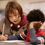 Odett Xiaomeng Ni, a student in a 2+2 partnership between Brenau and Anhui Normal University, works with a first grader at Fair Street International Academy on Friday, Feb. 2, 2018. (AJ Reynolds/Brenau University)