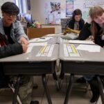 PC Chen Pan, a 2+2 education student from a partnership between Brenau and Anhui Normal University in China, and Hannah Adams, a junior early childhood education major, help students develop their stories for "Tiger Tales" at Fair Street International Academy on Friday, Feb. 2, 2018. (AJ Reynolds/Brenau University)