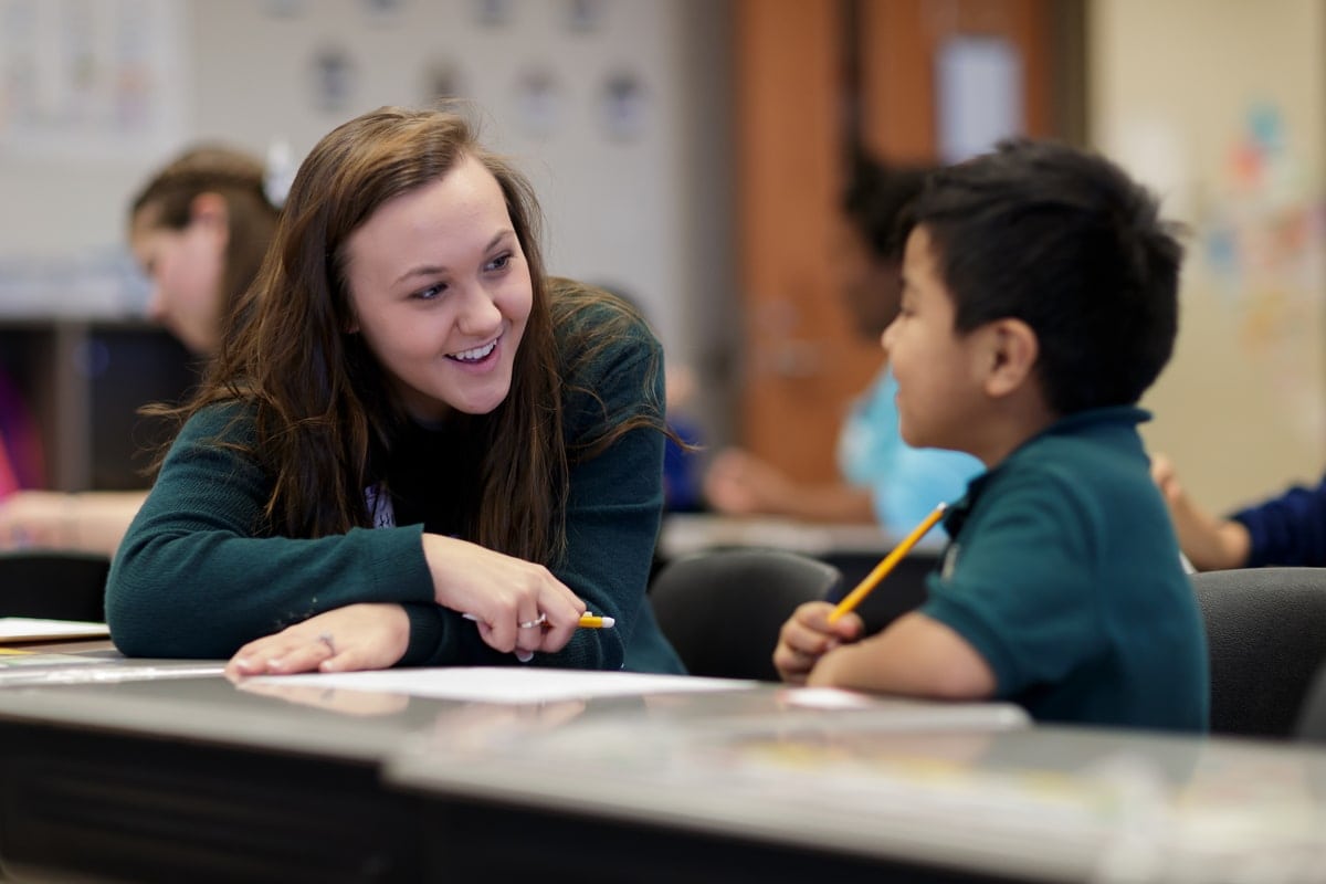 Brittany Brookins, a junior early childhood education major, works with a first grader on his story for 