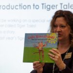 Dr. Lisa McCoy shows last year's "Tiger Tales" to a group of first grade students at Fair Street International Academy on Friday, Feb. 2, 2018.