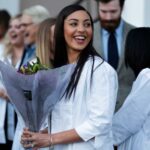 Nursing student with bouquet of flowers