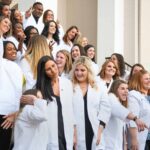 Nursing students pose for a photo on the steps of Pearce 3