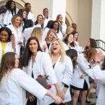 Nursing student cheering on the front steps of pearce