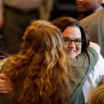 Parent hugging Nursing student