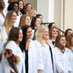 Nursing students pose for a photo on the steps of Pearce 2