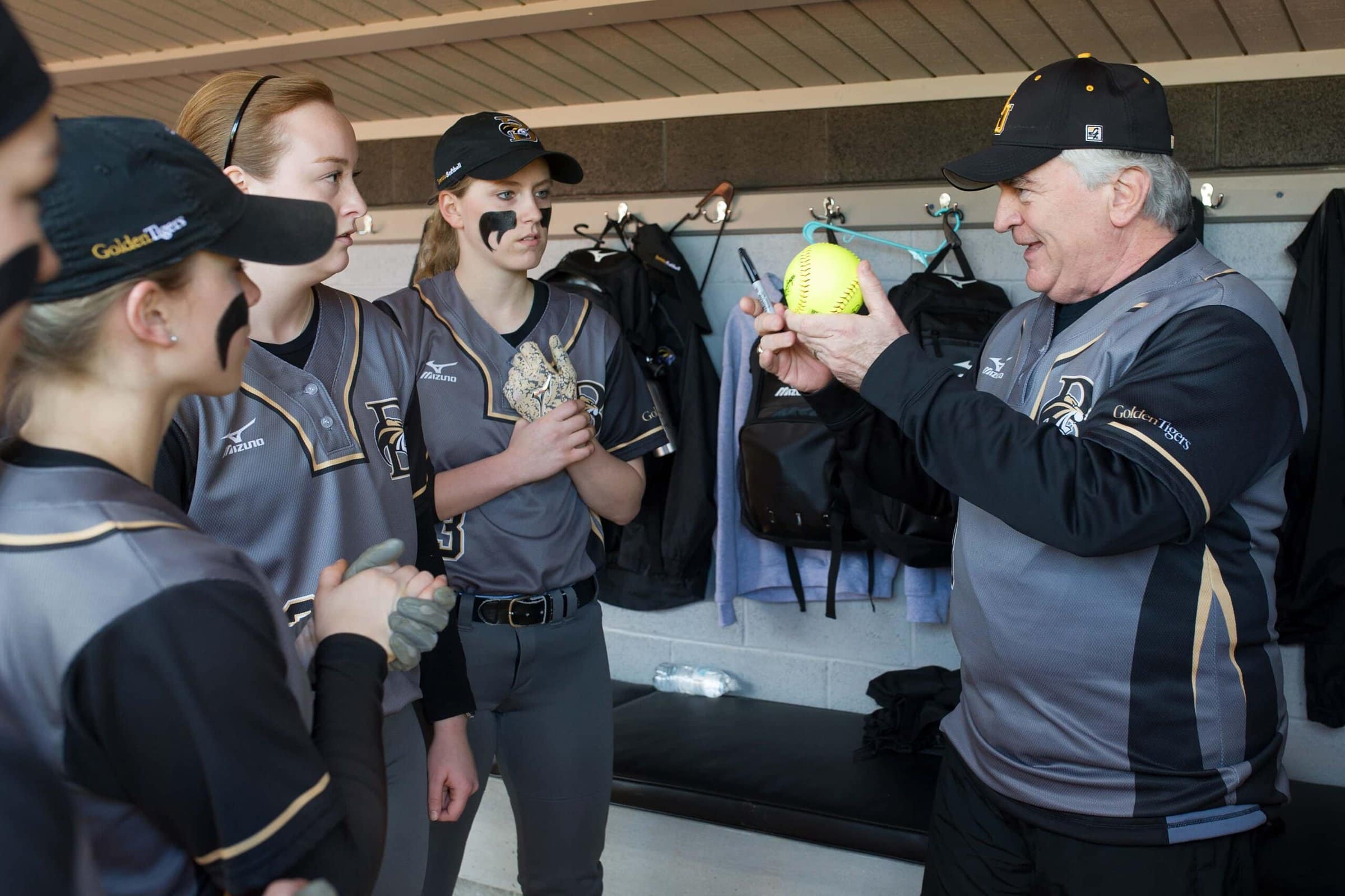 Brenau President Ed Schrader asks softball players to sign a ball to be placed in the Brenau archives to commemorate the first games at Pacolet Milliken Field at the Ernest Ledford Grindle Athletics Park between the Brenau Golden Tigers and Talladega College. (AJ Reynolds/Brenau University)