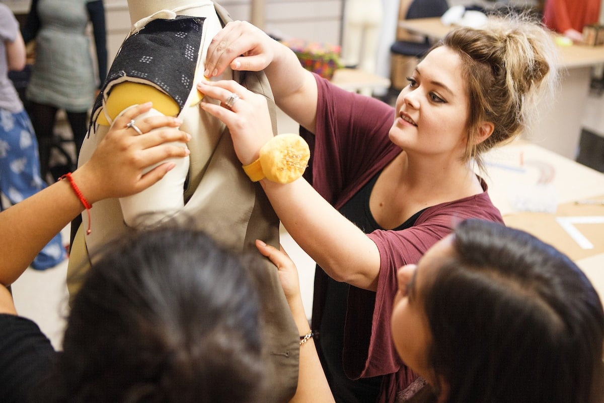 students work together with a dressing dummy