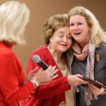 Dina Hewett, right, reacts as she gets a hug while receiving her award from Sandra Greniewicki during Masters in the Art of Nursing: Healers among us on Thursday, Feb. 15, 2018 at Whalen Auditorium in Brenau East in Featherbone Communiversity in Gainesville. (AJ Reynolds/Brenau University)