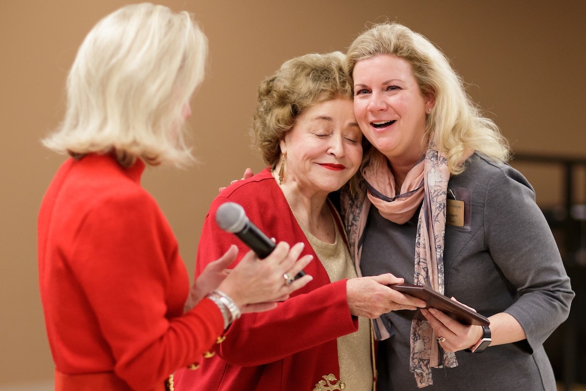 Dina Hewett, right, reacts as she gets a hug while receiving her award from Sandra Greniewicki during Masters in the Art of Nursing: Healers among us on Thursday, Feb. 15, 2018 at Whalen Auditorium in Brenau East in Featherbone Communiversity in Gainesville. (AJ Reynolds/Brenau University)