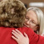 Eva Johnson hugs Sandra Greniewicki during Masters in the Art of Nursing: Healers among us on Thursday, Feb. 15, 2018 at Whalen Auditorium in Brenau East in Featherbone Communiversity in Gainesville. (AJ Reynolds/Brenau University)