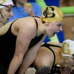 Swimmers cheer on other swimmers