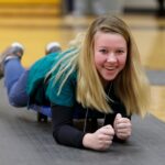 student crawling on floor