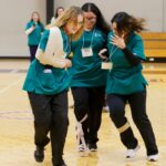 student with bandages helping each other