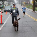 Brenau President walking his dog in Dempsey Dash