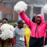 Woman in raincoat with pom poms