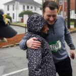 runner hugs woman