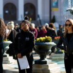 Jasmine Holt, from right, Tre'Linda Little and Ananda Skyers stand in silence during a remembrance for the victims of the mass shooting at Marjory Stoneman Douglas High School. Brenau students, staff and faculty gathered around the Grace Hooten Moore Memorial Fountain and read the names of each victim after a bell rang from Grace Episcopal Church in memory. (AJ Reynolds/Brenau University)