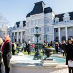 Brenau students stand in silence around fountain