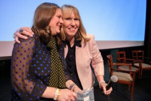 Emmie Howard, Brenau alumna and founder of clothing brand Southern Proper, gets a hug from Debra Dobkins, dean of The Women's College. Howard gave out Southern Proper t-shirts to all the attendees at Women's Leadership Colloquium on Friday, March 15. (AJ Reynolds/Brenau University)