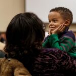 David Little, 4, listens as his mother Adondra Little takes part in the Masters of Teaching: Life Changers at Work on Wednesday, March 21, 2018. (AJ Reynolds/Brenau University)