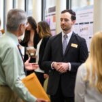 Jacob Weller speaks with Bob Cantu during the symposium.