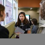 Joanna Chen talks to other students during the symposium.