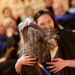 Daniella Santiago and Gay Hammond hug during Honors Convocation.