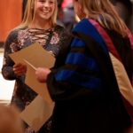 Mason Garland talks with Heather Holliman after receiving an award during the Brenau University Honors Convocation on Thursday, April 12, 2018. (AJ Reynolds/Brenau University)