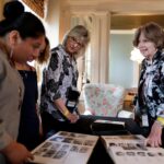 Marcia Meliski Stoke, WC '68, and Lynne Serge Doby look at their yearbooks with Emma Light and Bianca Orr during Alumnae Reunion Weekend on Friday, April 13, 2018. (AJ Reynolds/Brenau University)