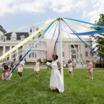 Members of the May Court prepare to wrap the Maypole around May Queen Simone Lewis. (AJ Reynolds/Brenau University)