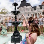 Lauren LaRicci reacts as her Phi Mu sisters throw her into the Grace Hooten Moore Memorial Fountain in celebration of her engagement. (AJ Reynolds/Brenau University)