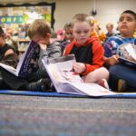 Students read on the floor.