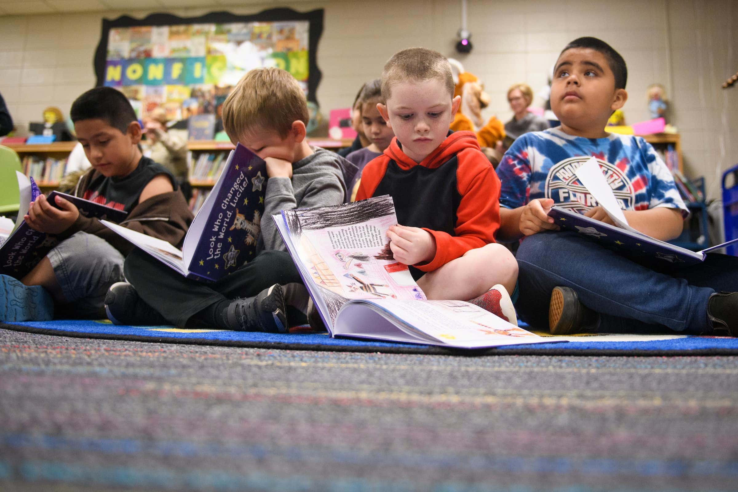 Students read on the floor.