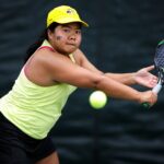 Peeraya Charoensirisutthikul stretches to hit a backhand during her match. (AJ Reynolds/Brenau University)