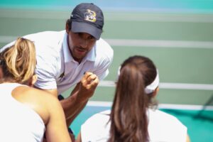 Brenua head coach Andre Ferreira gives direction between games during the semifinal round of the Appalachian Athletic Conference women's tennis championships on Saturday, April 21, 2018, in Chattanooga Tenn. Brenau defeated Reinhardt 5-0. 