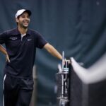 Brenau head coach Andre Ferreira laughs before the start of doubles during the final round of the Appalachian Athletic Conference women's tennis championships on Sunday, April 22, 2018, in Chattanooga Tenn. Brenau defeated SCAD Atlanta 5-0 to win the AAC Championship. (AJ Reynolds/Brenau University)