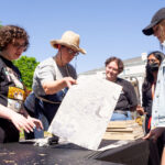 Wilburn teaches printmaking during the Spring Showcase of the Arts.