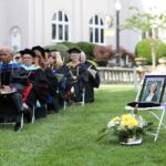 Brenau University faculty sit near an empty seat in honor of the late Jolie Long Carlton, a Brenau University professor and chair of the department of dance, during the Women's College Commencement at Brenau University Friday May 4, 2018 in Gainesville, Ga. (Jason Getz for Brenau University)