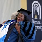 Kenya Hunter hugs Brenau University President Ed Schrader after she received her diploma during the Women's College Commencement at Brenau University Friday May 4, 2018 in Gainesville, Ga. (Jason Getz for Brenau University)