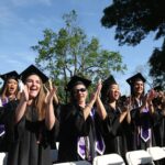 Nursing school graduates cheer on fellow nursing students as they receive their diplomas during the Women's College Commencement at Brenau University Friday May 4, 2018 in Gainesville, Ga. (Jason Getz for Brenau University)