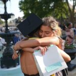 Margaret Holtkamp, facing, hugs Ella Kleinschmidt after Kleinschmidt's graduation at the conclusion of the Women's College Commencement at Brenau University Friday May 4, 2018 in Gainesville, Ga. (Jason Getz for Brenau University)