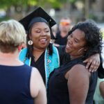Graduate Shequonna Holden, center, celebrates with her mother Rosheenah Oglesby, of Toccoa, at the conclusion of the Women's College Commencement at Brenau University Friday May 4, 2018 in Gainesville, Ga. (Jason Getz for Brenau University)