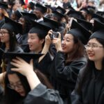 May 5, 2018 - Gainesville, Ga: ANU-Brenau University student Zirui "Emily" Hong takes a photograph during the graduate and undergraduate commencement Saturday May 5, 2018 in Gainesville, Ga. (Jason Getz for Brenau University)