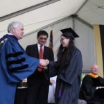 An ANU student Xinning Rachel Pei receives her diploma from Brenau University President Ed Schrader, left, and ANU Provost Duanming Zhou, center, during graduate and undergraduate commencement Saturday May 5, 2018 in Gainesville, Ga. (Jason Getz for Brenau University)