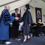 ANU-Brenau University student Xinyan Daisy Qiu receives her diploma from Brenau University President Ed Schrader, left, and ANU Provost Duanming Zhou, center, during graduate and undergraduate commencement Saturday May 5, 2018 in Gainesville, Ga. (Jason Getz for Brenau University)